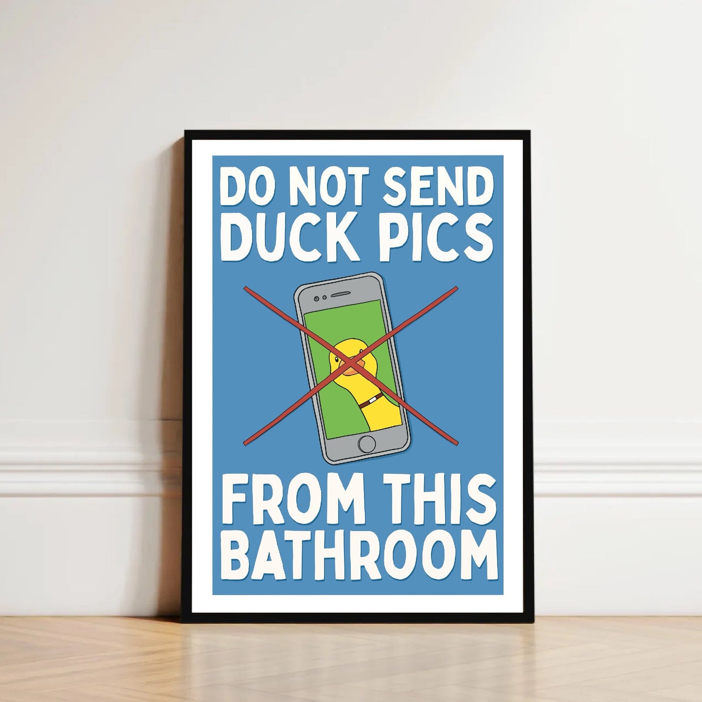 Framed poster with humorous message about duck pics on a wall.