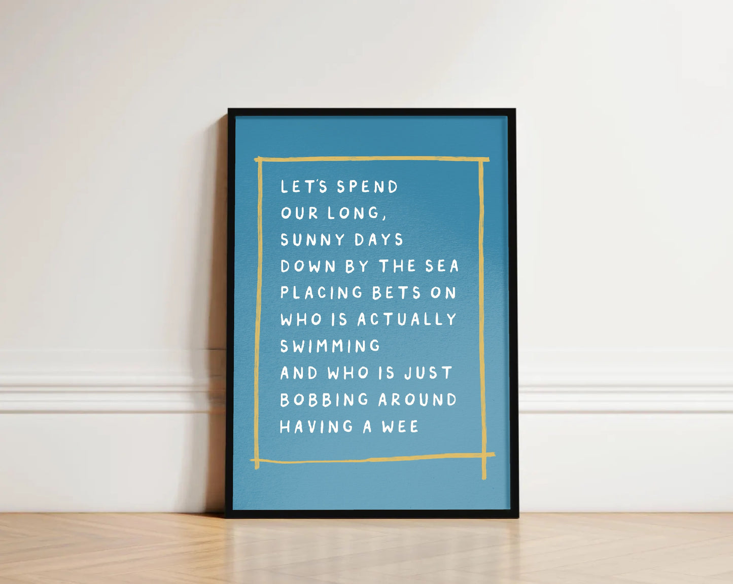 Framed blue poster with white text on a white wall