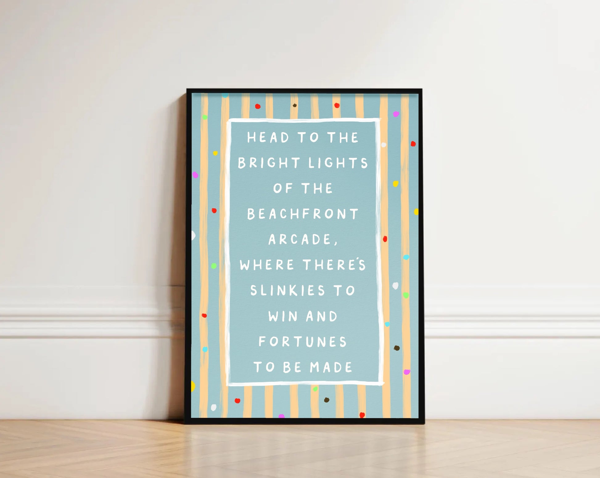 Framed text beach art print on a wall with colorful striped border