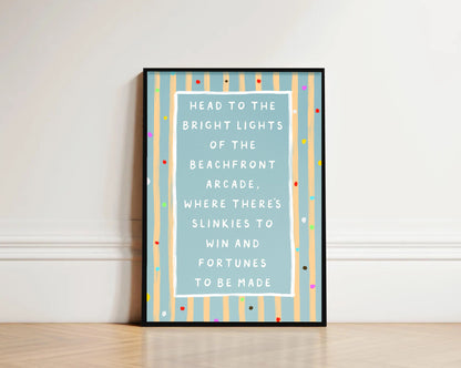 Framed text beach art print on a wall with colorful striped border