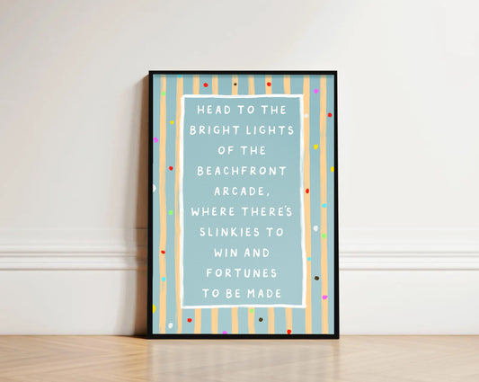 Framed text beach art print on a wall with colorful striped border